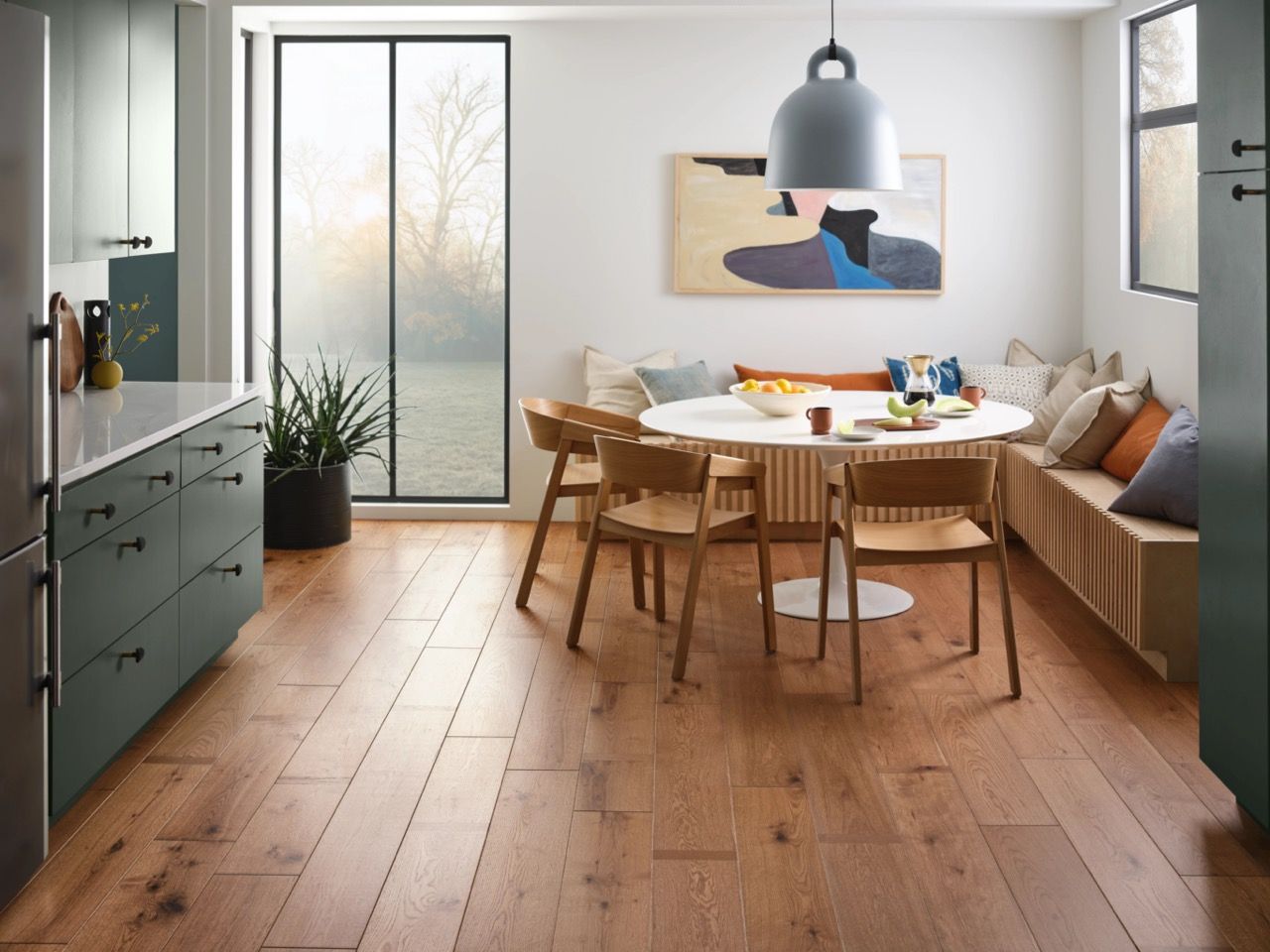 a dining room with a table and chairs and a painting on the wall