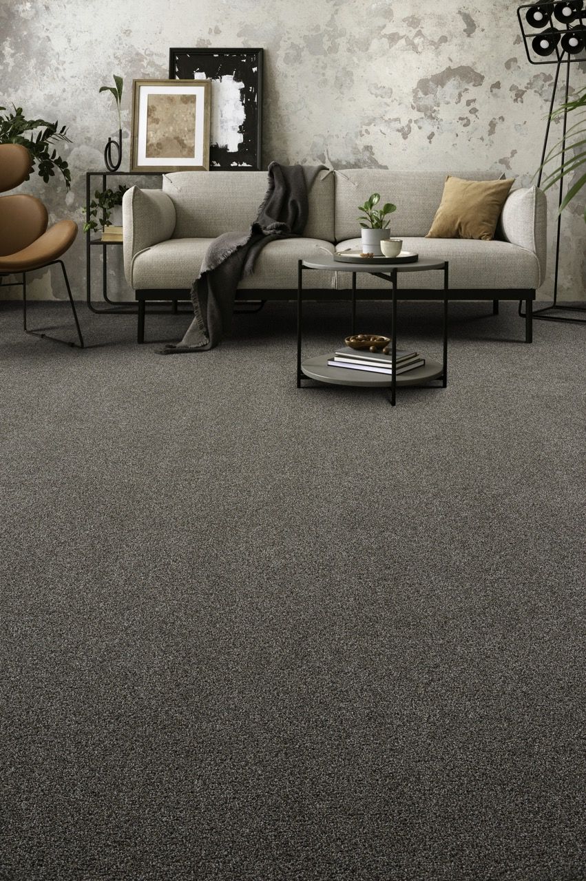 a living room with a couch, chair, table and carpet