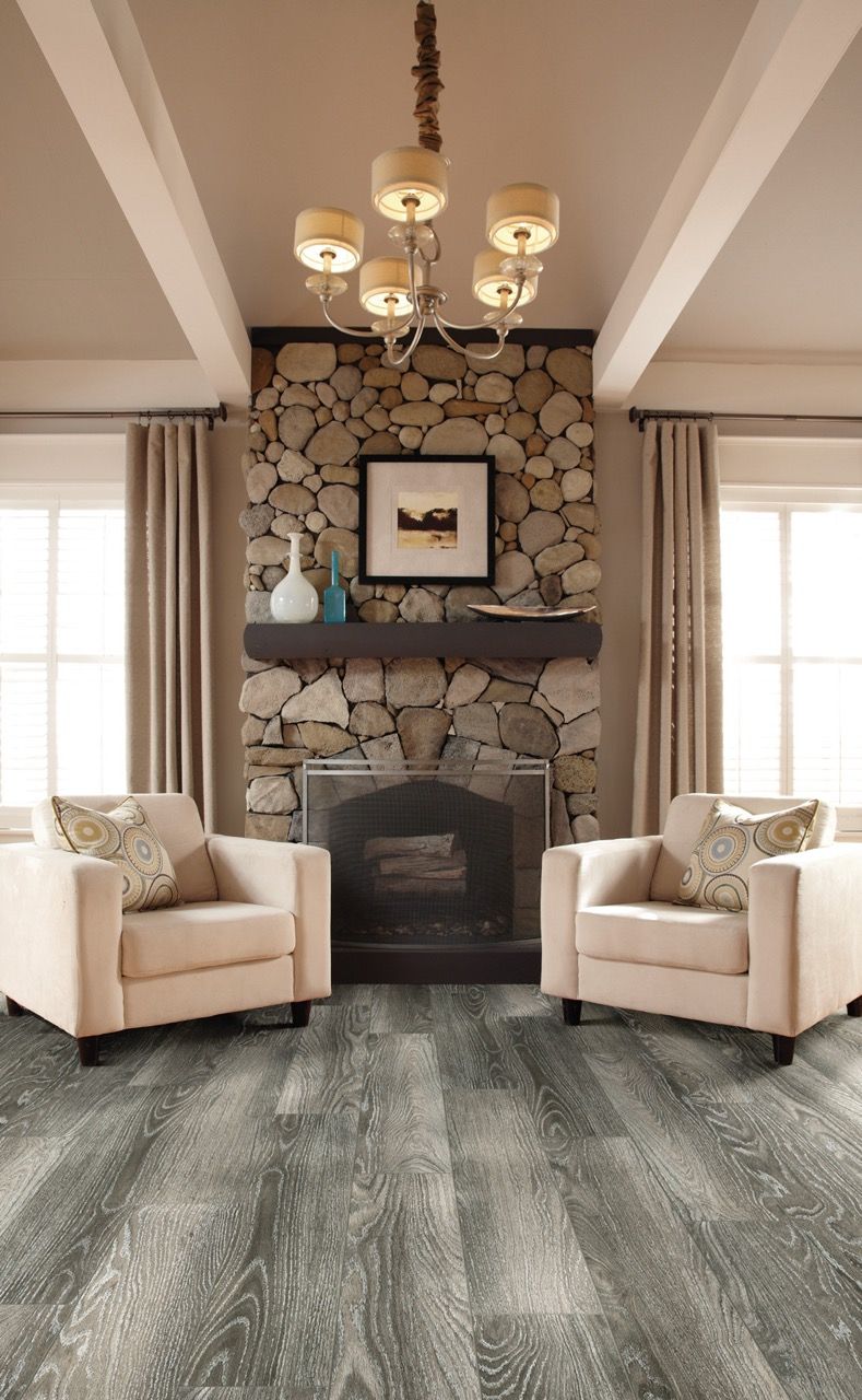 a living room with two chairs and a fireplace