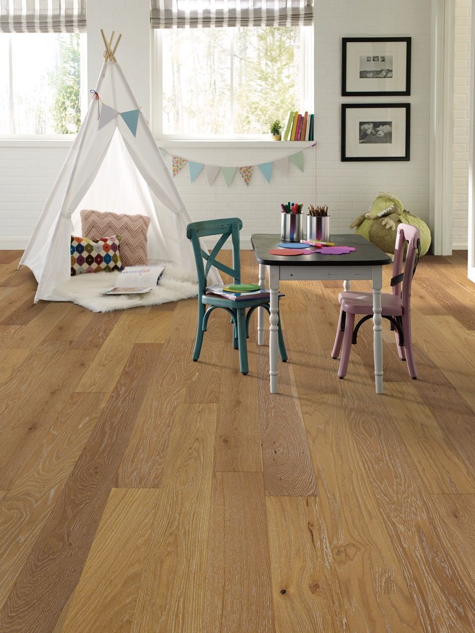 a children's room with a teepee and a table and chairs