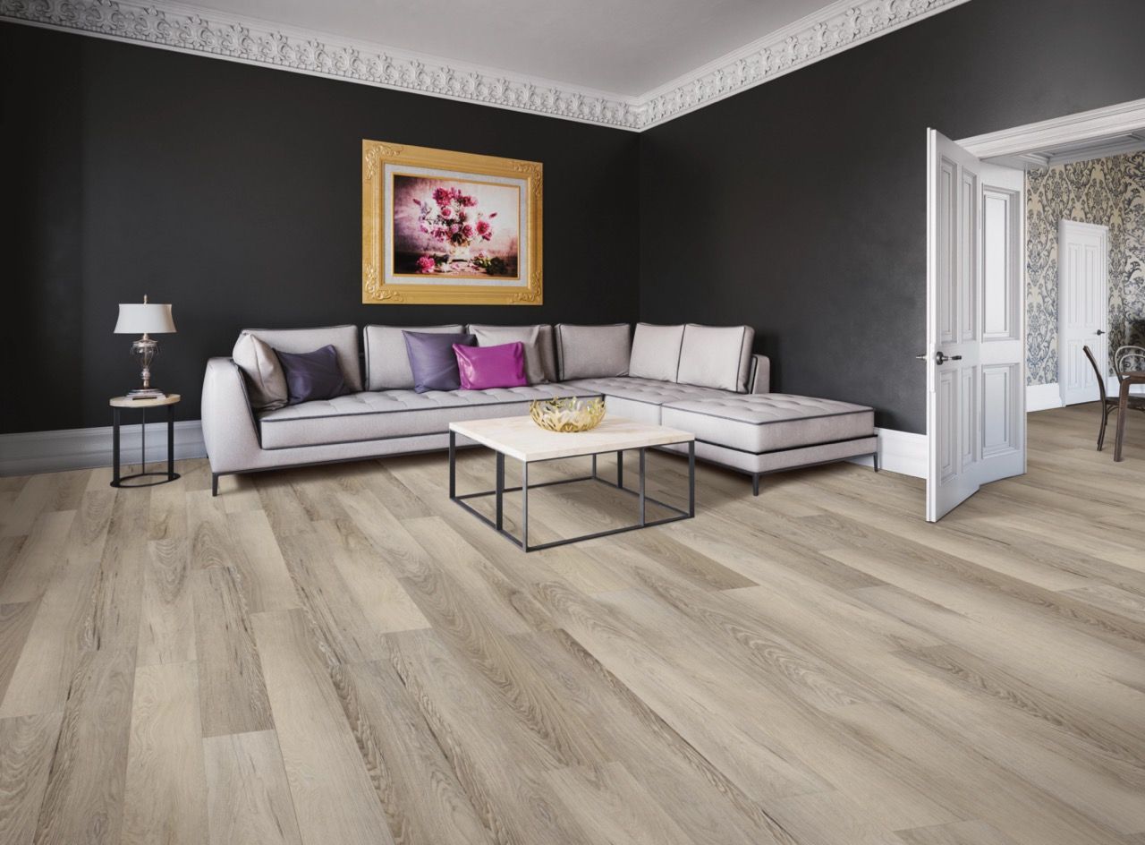 a living room with a couch, coffee table, and painting on the wall