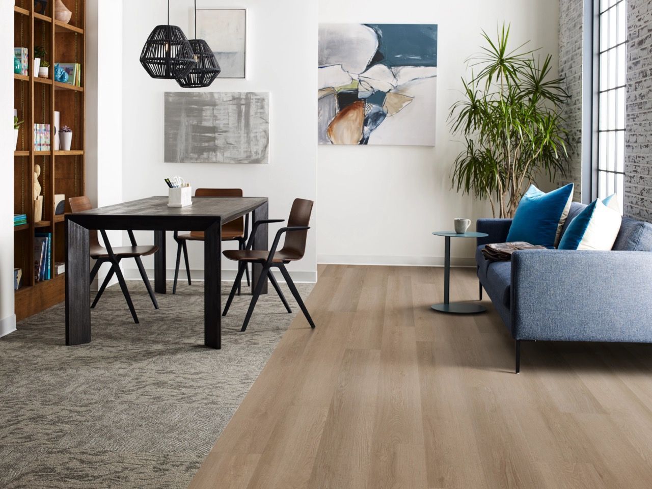 a living room with a couch, table, chairs and a painting on the wall