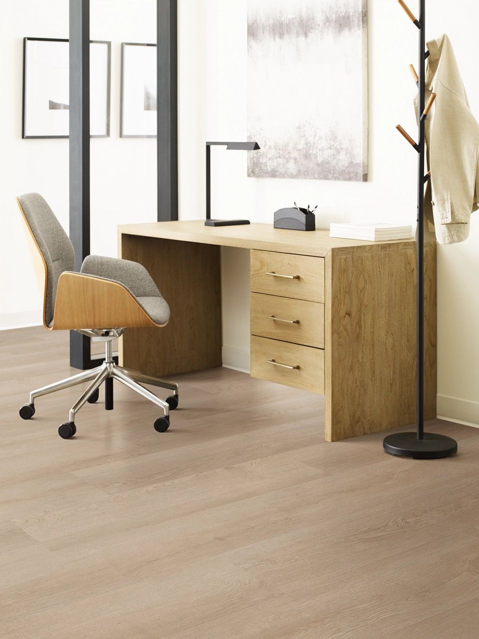 a wooden desk with a chair and a coat rack