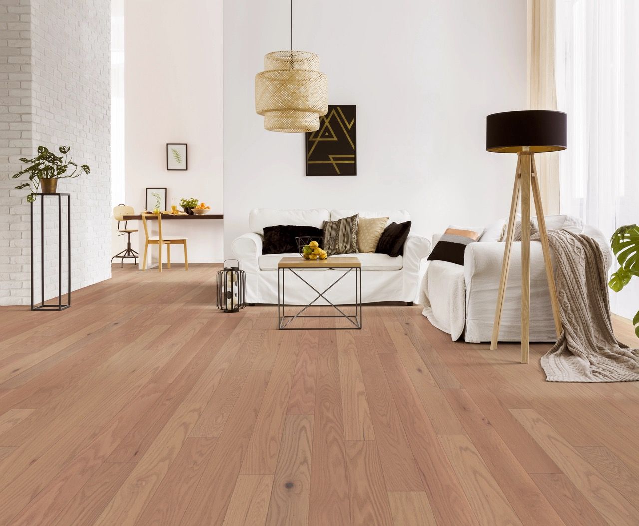 a living room with hardwood floors and a white couch