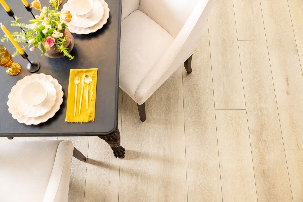 an aerial view of a dining room table and chairs