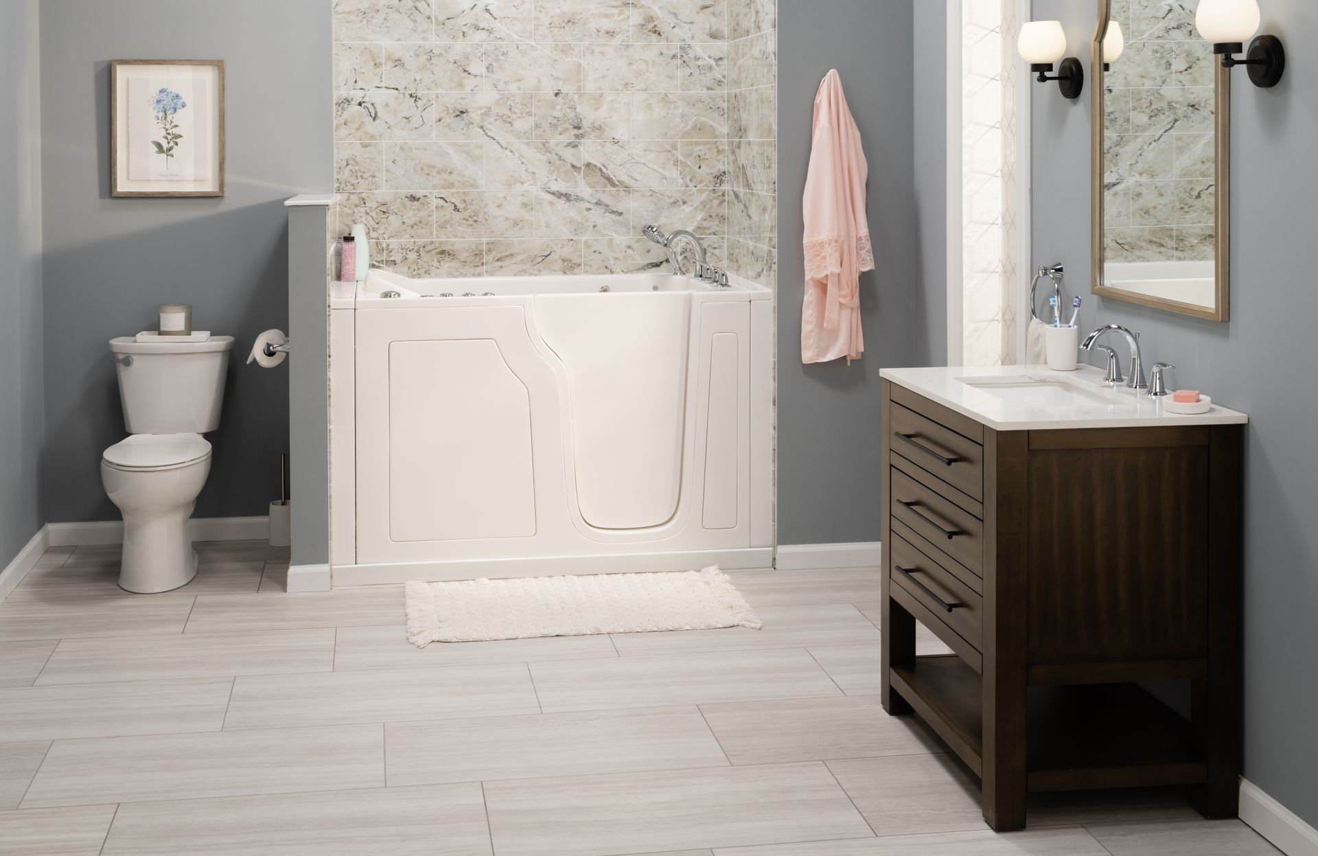 A bathroom with a walk-in tub, toilet, sink, and mirror.