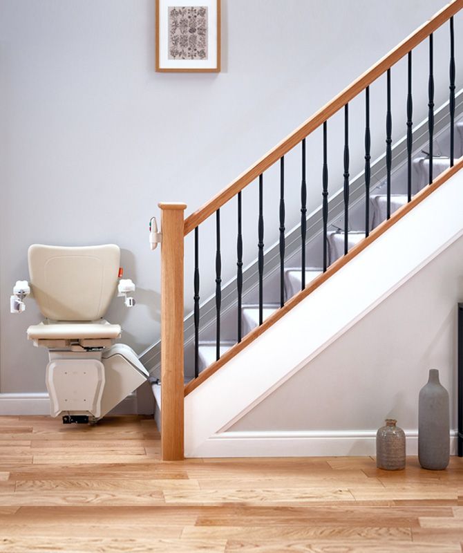 A chair is sitting in front of a set of stairs.