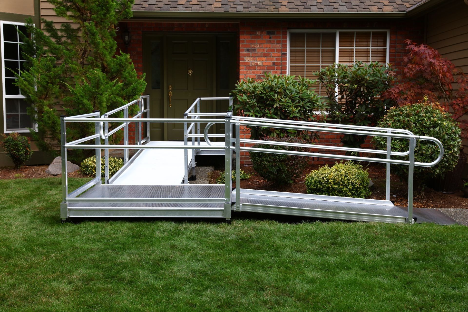 A wheelchair ramp is in front of a brick house