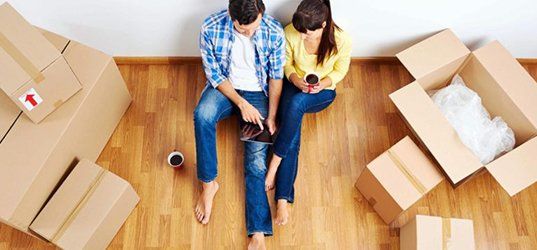 Couple sitting with boxes