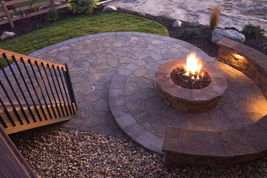 There is a fire pit in the middle of the patio.
