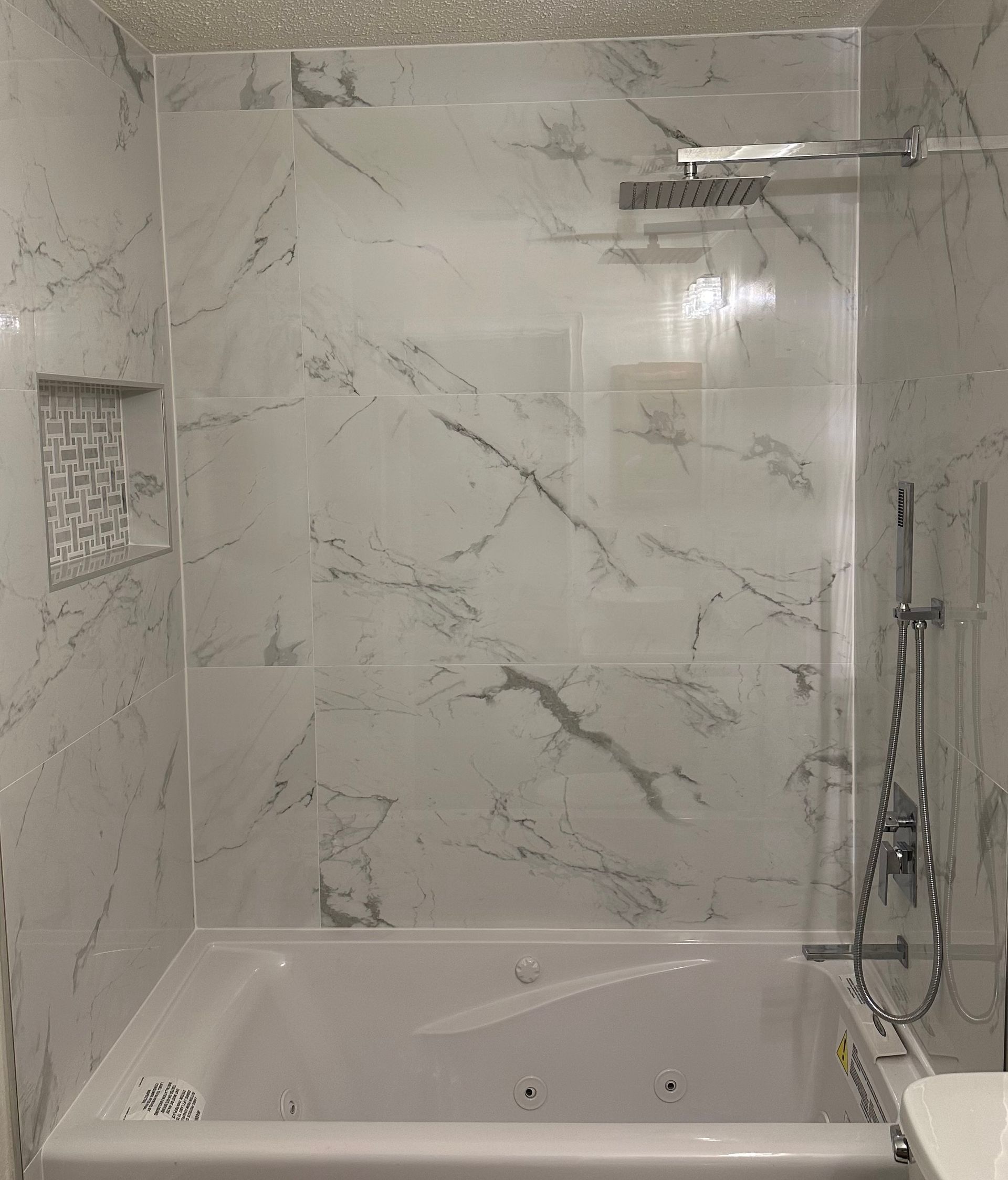 A bathroom with a bathtub and a shower.