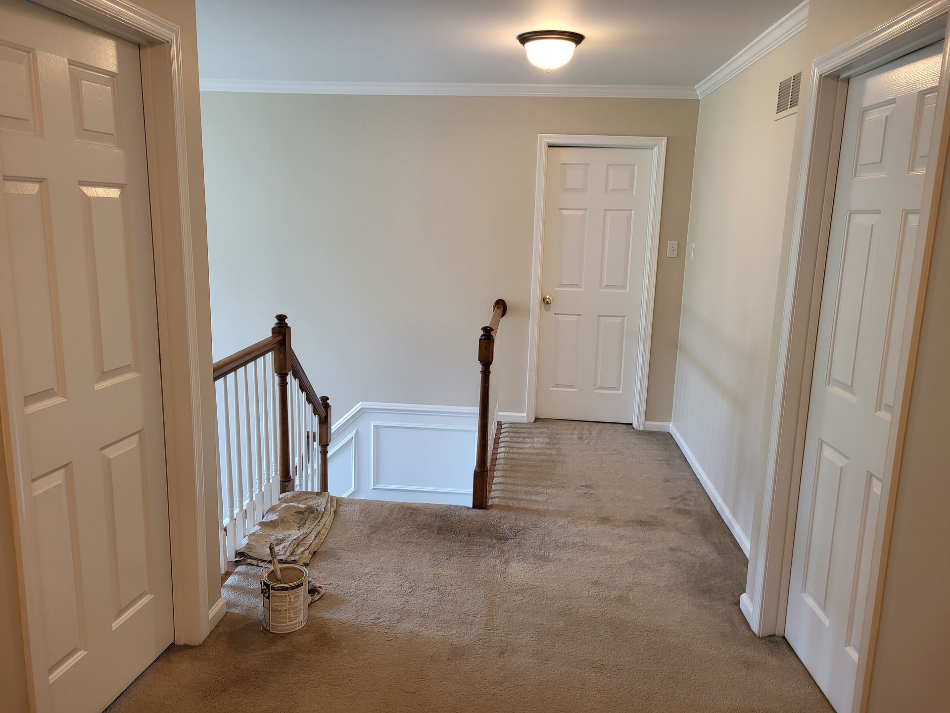 A hallway with stairs leading up to the second floor of a house.