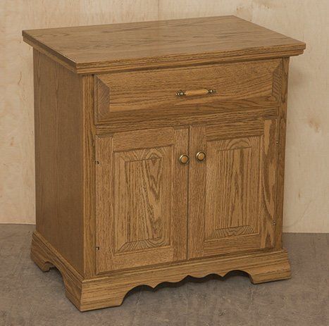 A small wooden cabinet with two doors and a drawer