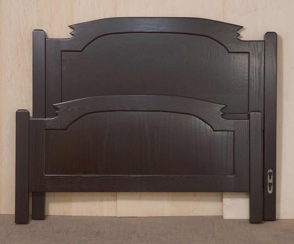 A wooden headboard with a ribbon on it