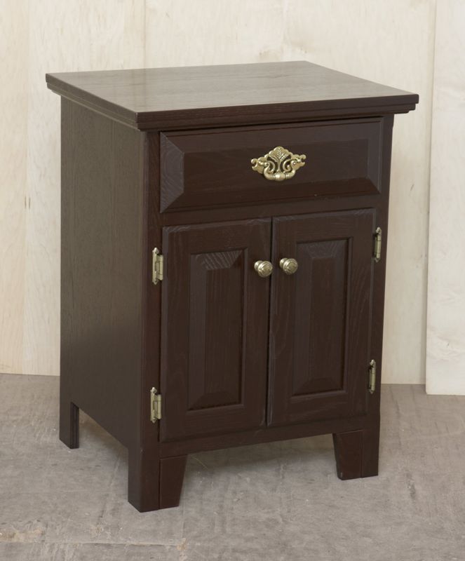 A small wooden cabinet with a drawer and two doors