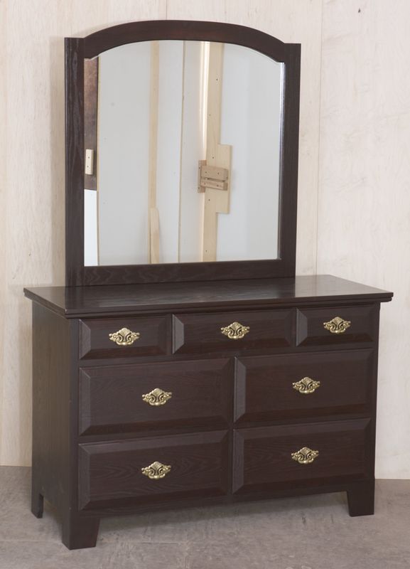 A dresser with a mirror on top of it