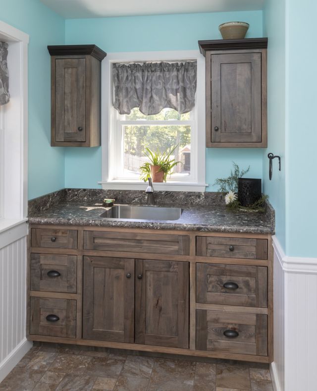 A kitchen with wooden cabinets and a sink