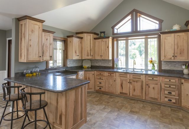 A kitchen with wooden cabinets and granite counter tops