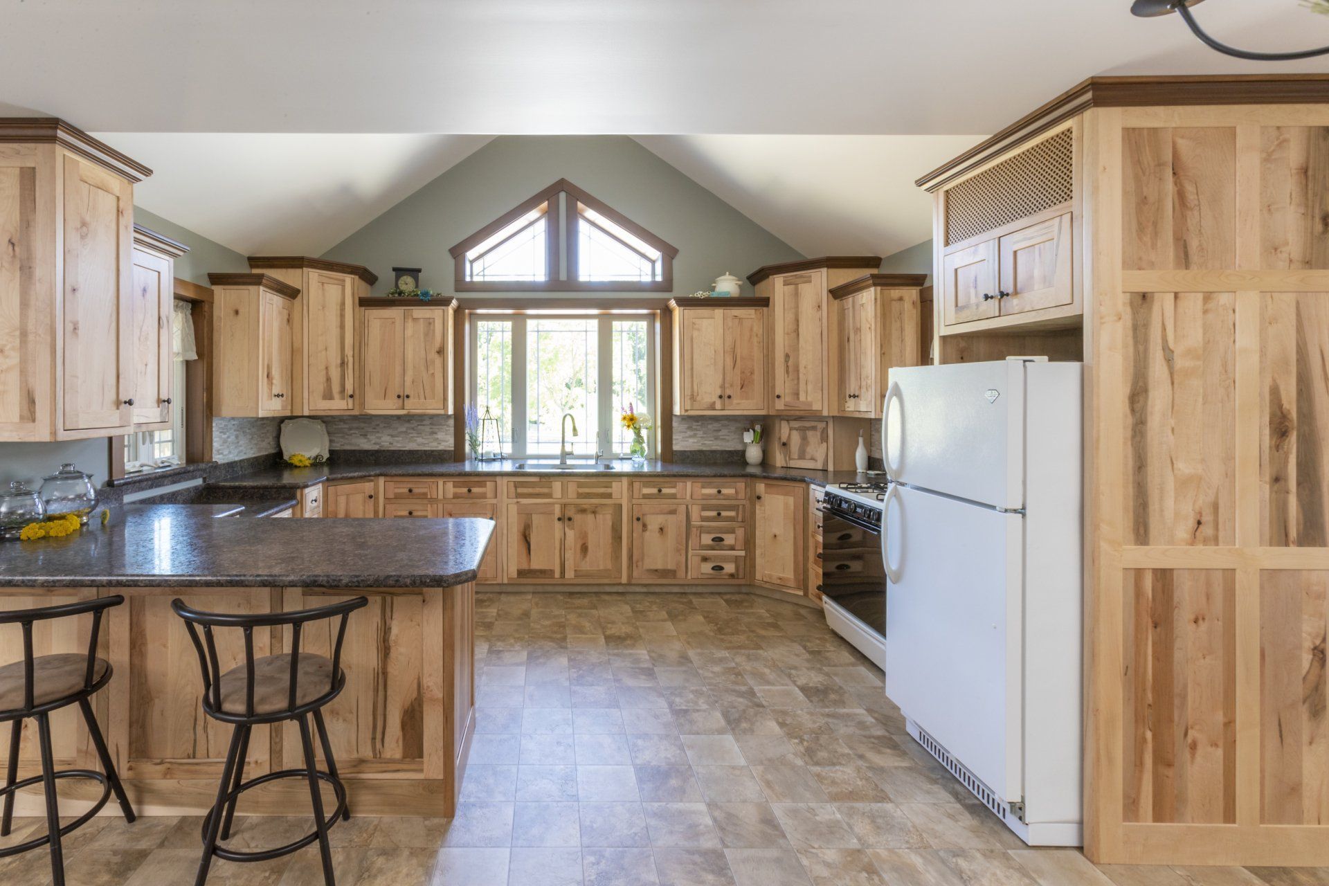 A kitchen with wooden cabinets and a white refrigerator