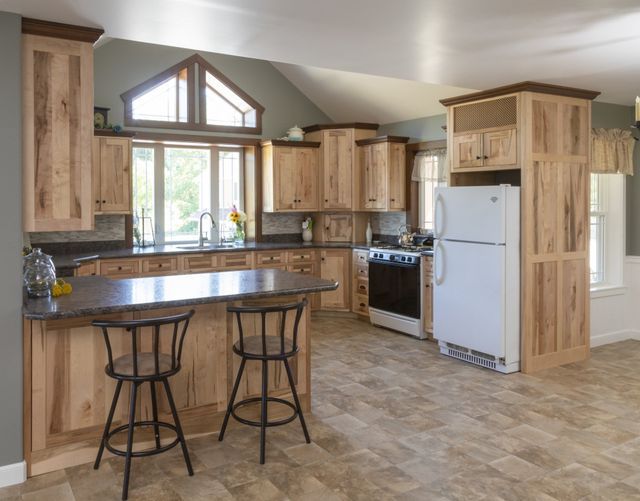 A kitchen with wooden cabinets and a white refrigerator