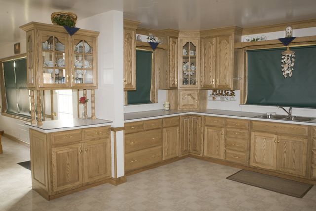 A kitchen with wooden cabinets and a sink