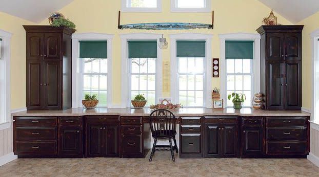 A kitchen with lots of cabinets and a chair