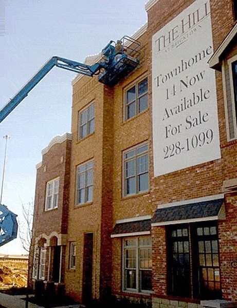 Townhomes under construction, workers in lift, large 