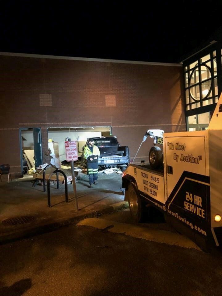 Pickup truck being pulled from an old parking space