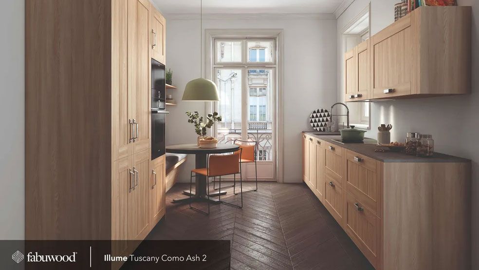 A kitchen with wooden cabinets and a table and chairs.