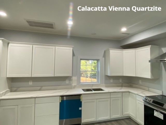 A kitchen with white cabinets and stainless steel appliances