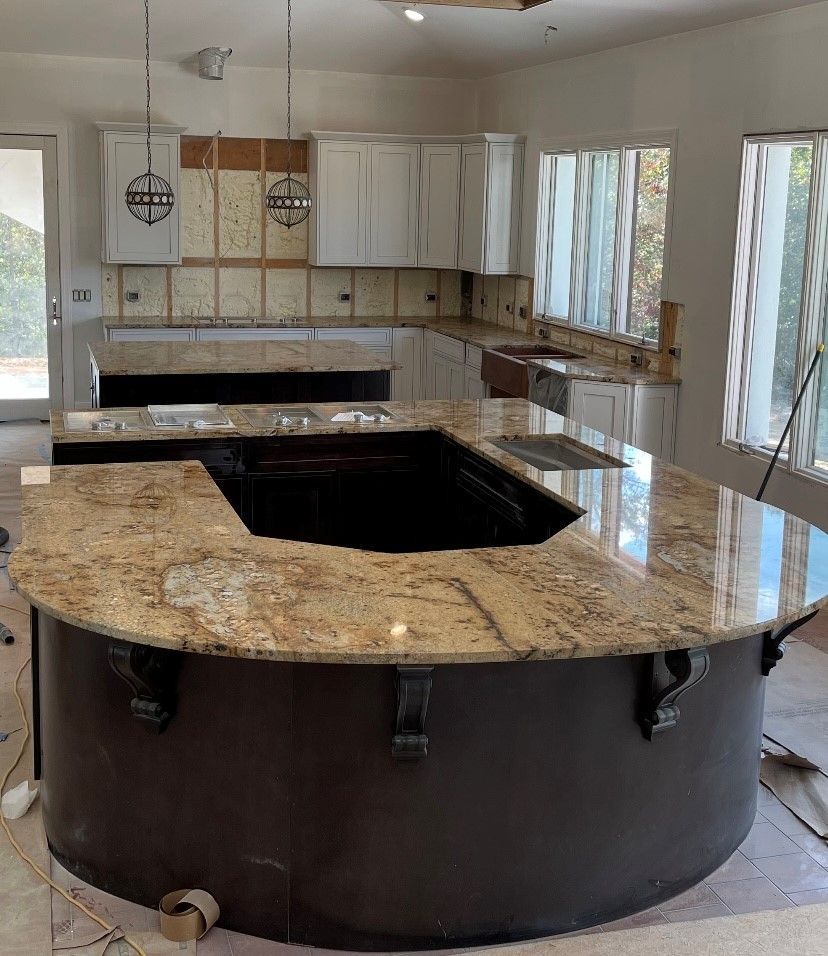 A kitchen with a large island and granite countertops