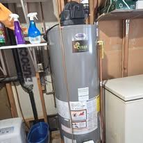 Water heater with accessories in a storage room.