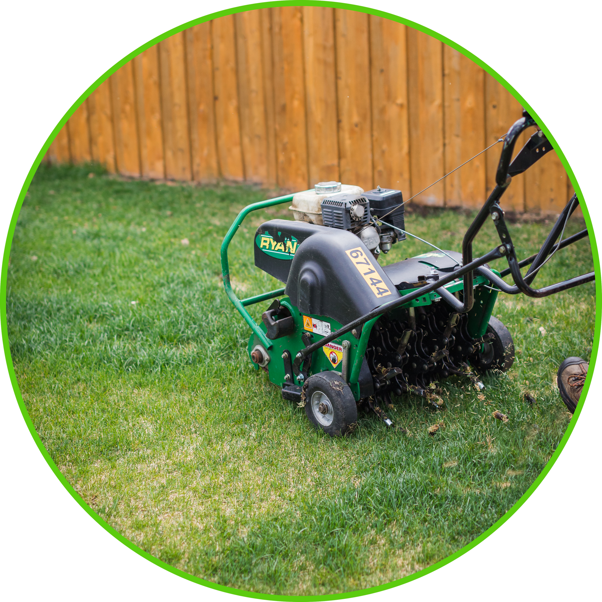 a man is pushing a lawn mower down a sidewalk