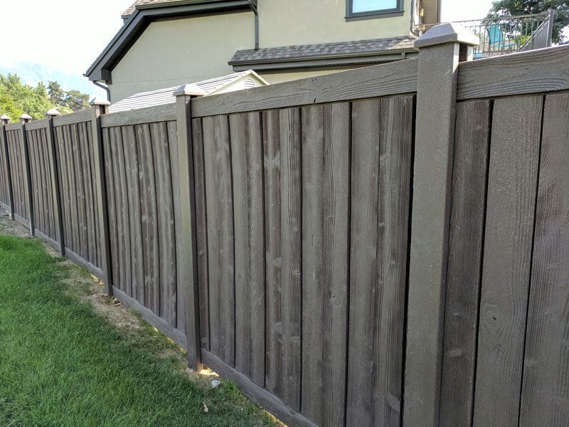 Wooden privacy fence painted gray in a residential yard.