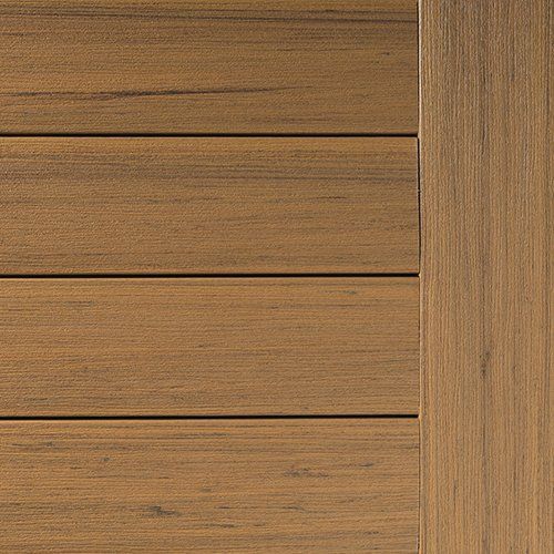 Brown composite deck boards with a vertical board on the right.