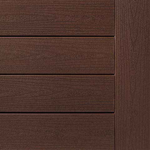 Close-up of brown composite decking with horizontal planks and vertical border.
