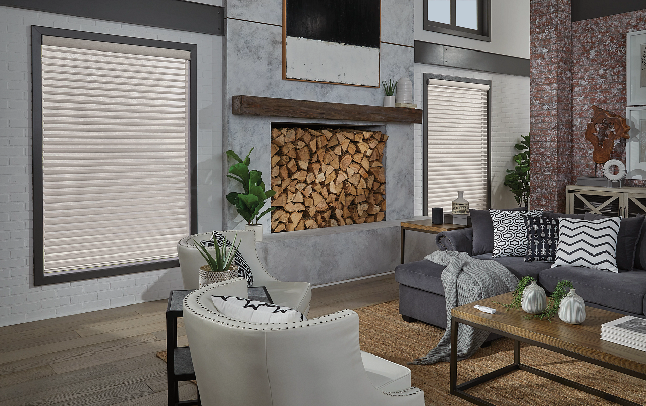 Modern living room with gray sectional, white chair, wood fireplace, and large windows with blinds
