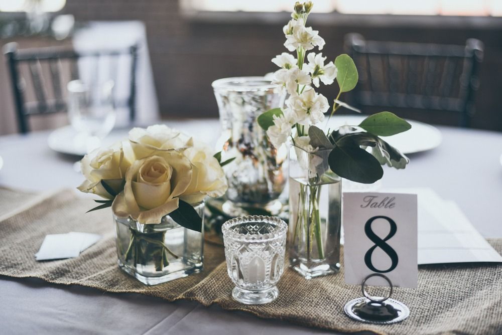 Table setting with white flowers and table number 8.