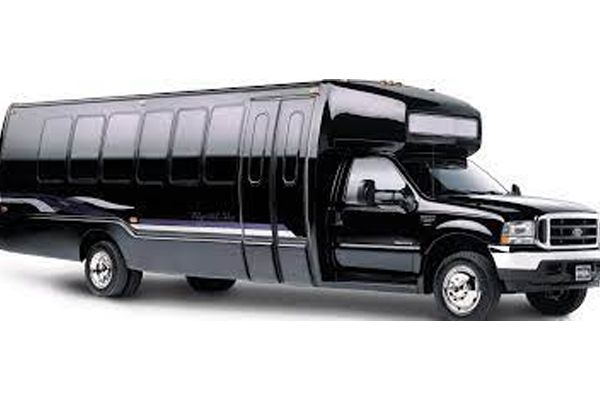 Black party bus with tinted windows, parked on a white background.