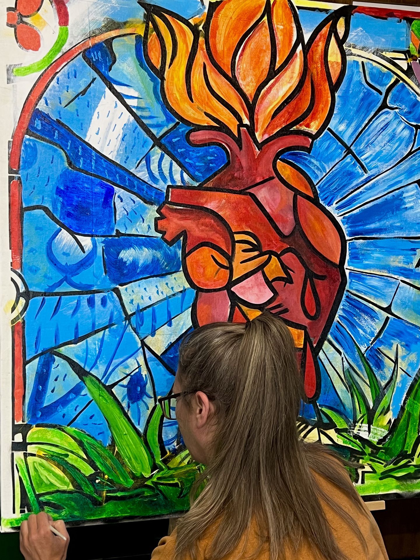 Artist painting a large, stylized heart