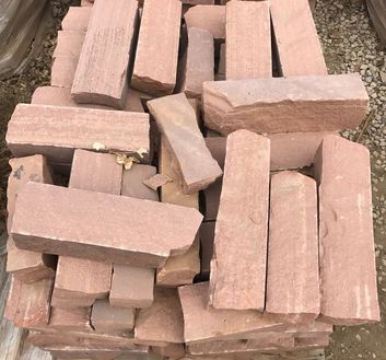A pile of pink bricks stacked on top of each other