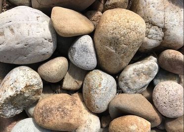 A pile of rocks sitting on top of each other on the ground.