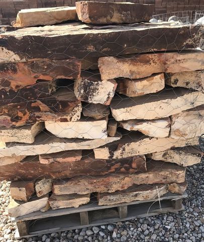 A pile of rocks stacked on top of each other on a wooden pallet.