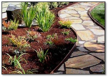A stone walkway in a garden surrounded by plants