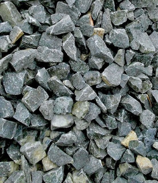 A pile of rocks is sitting on the ground.