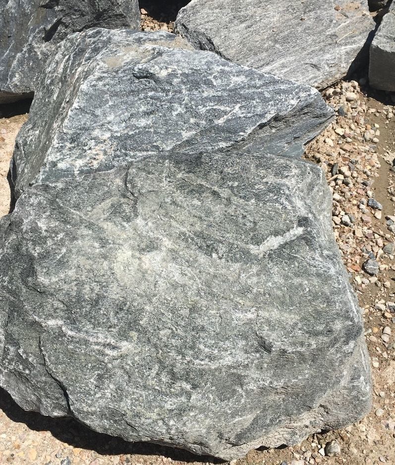 A large rock is sitting on top of a pile of rocks.