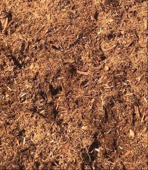 A close up of a pile of brown mulch.