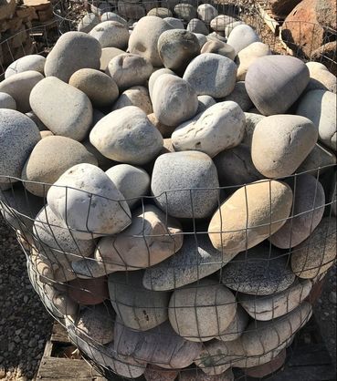 A pile of rocks sitting on top of each other in a cage.