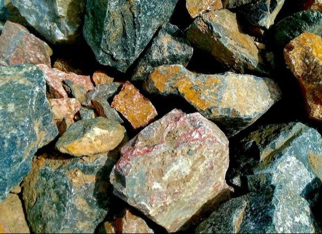 A pile of rocks with a lot of different colored rocks