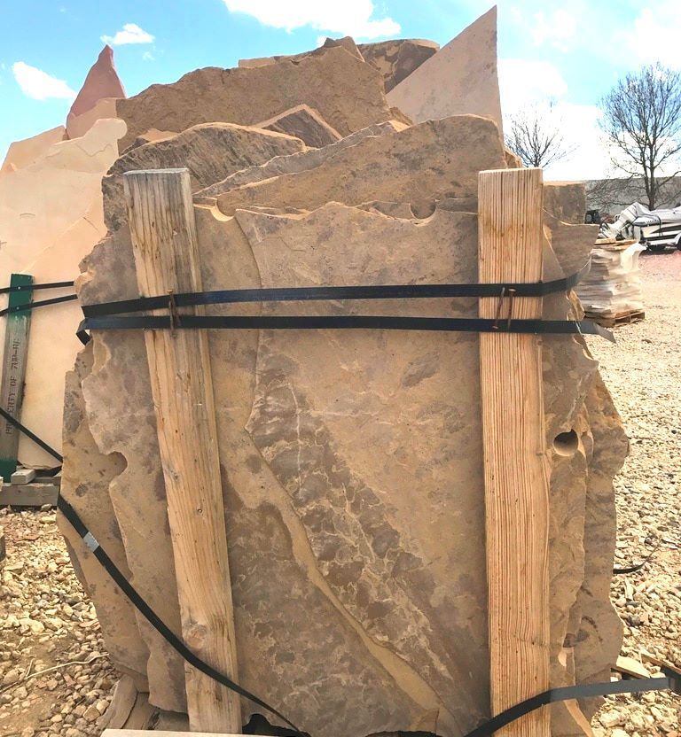 A large rock is tied to a wooden pallet